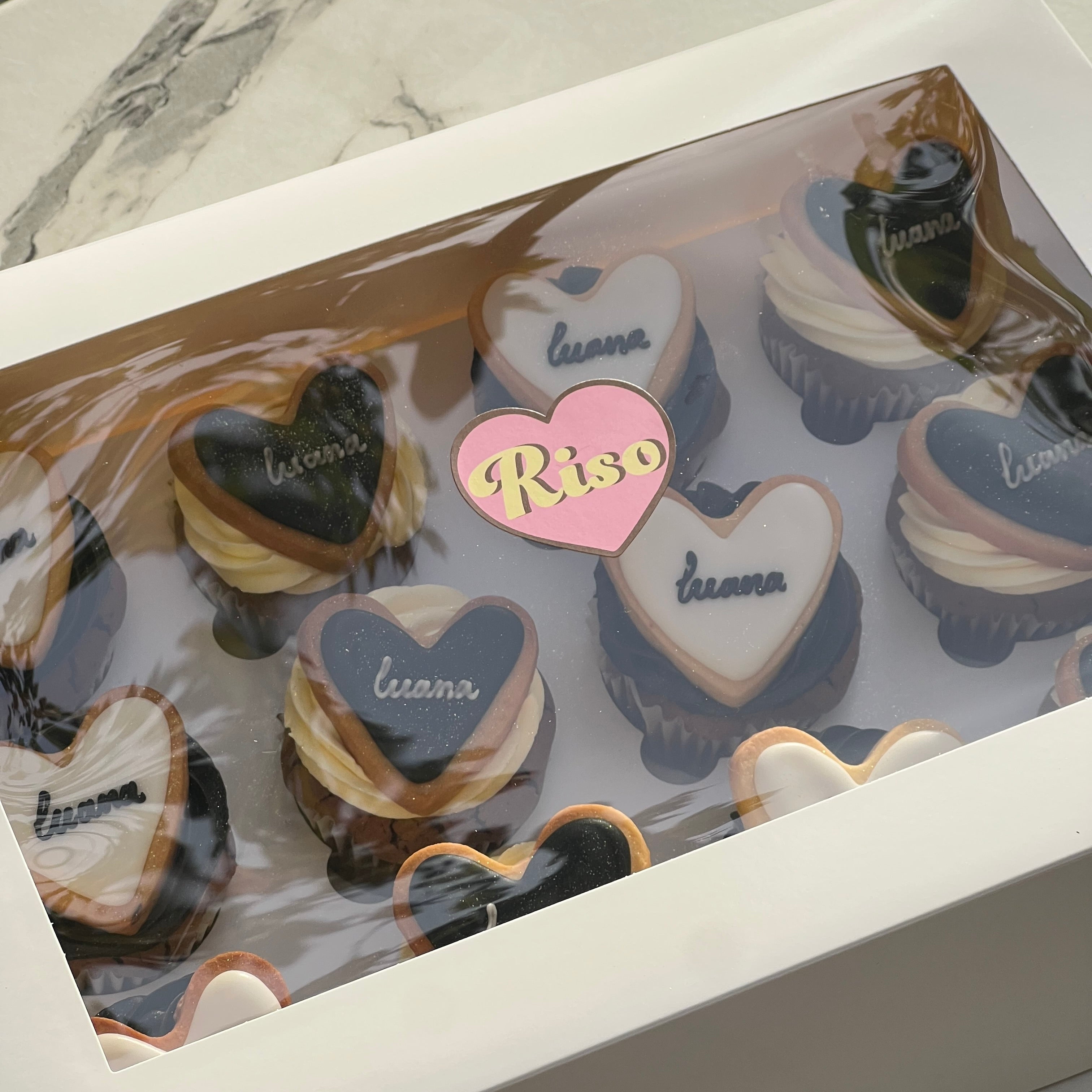 Sunlit cupcakes with elegant heart cookies and soft buttercream swirls, perfect for stylish celebrations