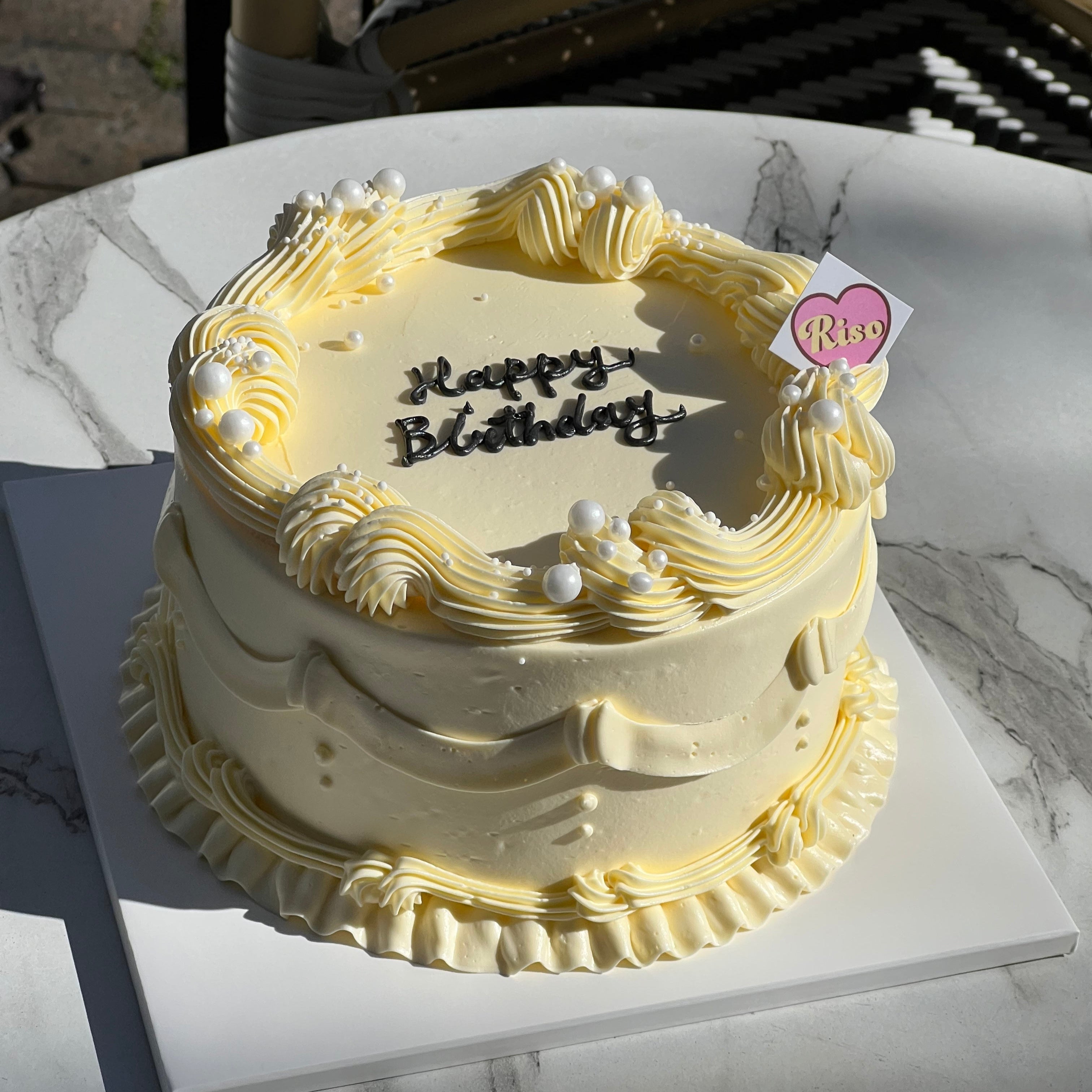 Riso Cake’s vintage gender reveal cake – cream piping with surprise pink or blue filling inside