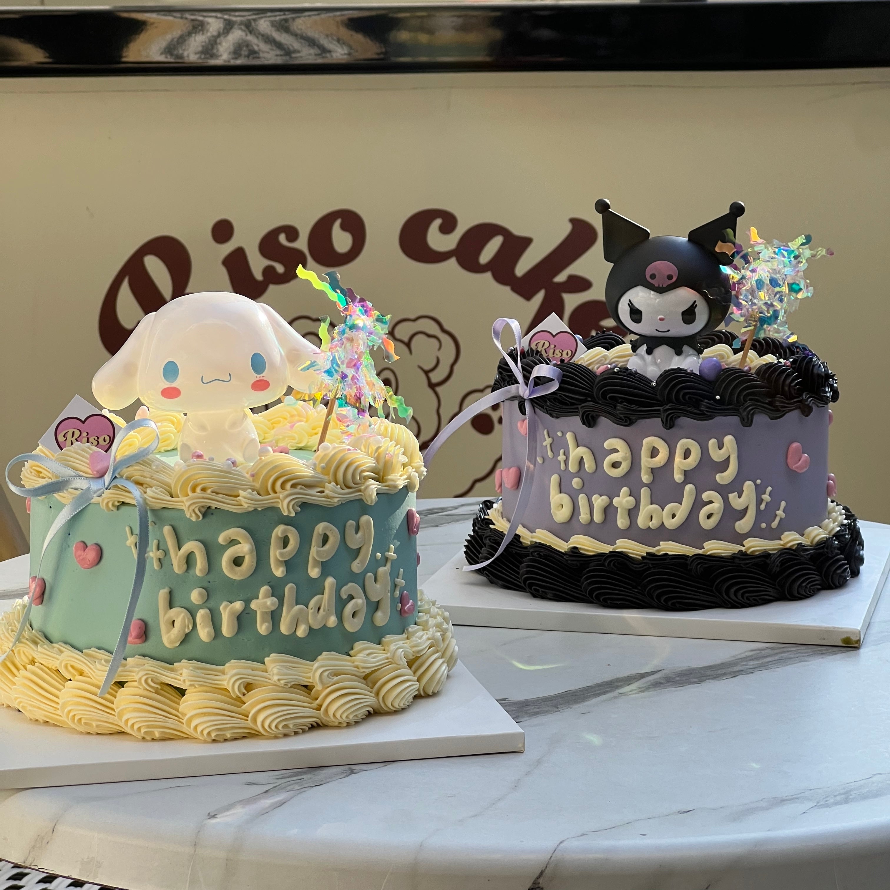 Adorably gothic birthday cake featuring a 3D Kuromi topper, sweet hearts, and bold buttercream piping