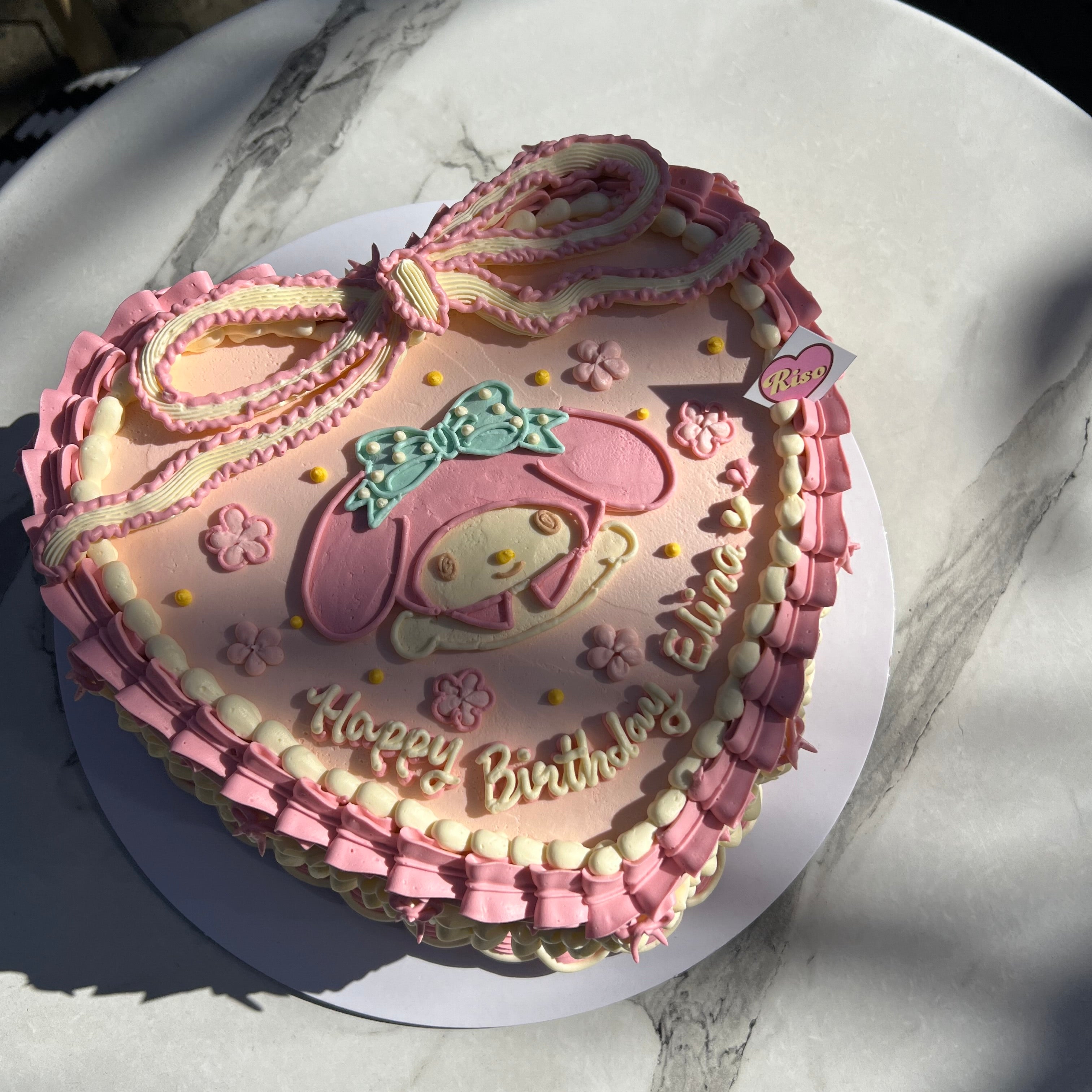 My Melody birthday cake with piped buttercream ribbon, frilly vintage borders, and charming pink and ivory details — ideal for Sanrio lovers and girly party themes