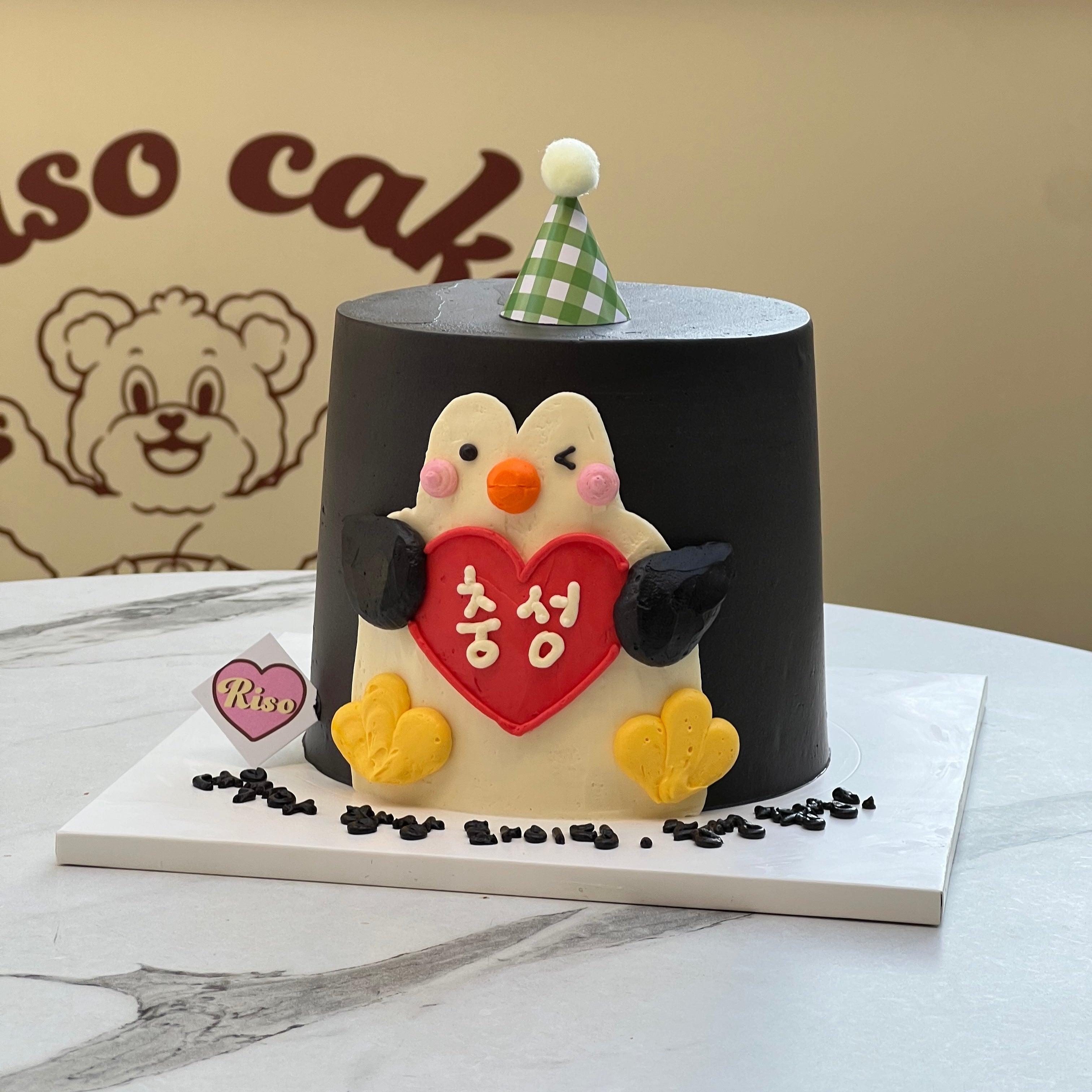 A charming and humorous cake featuring a blushing penguin hugging a red heart — playful, bold, and full of personality