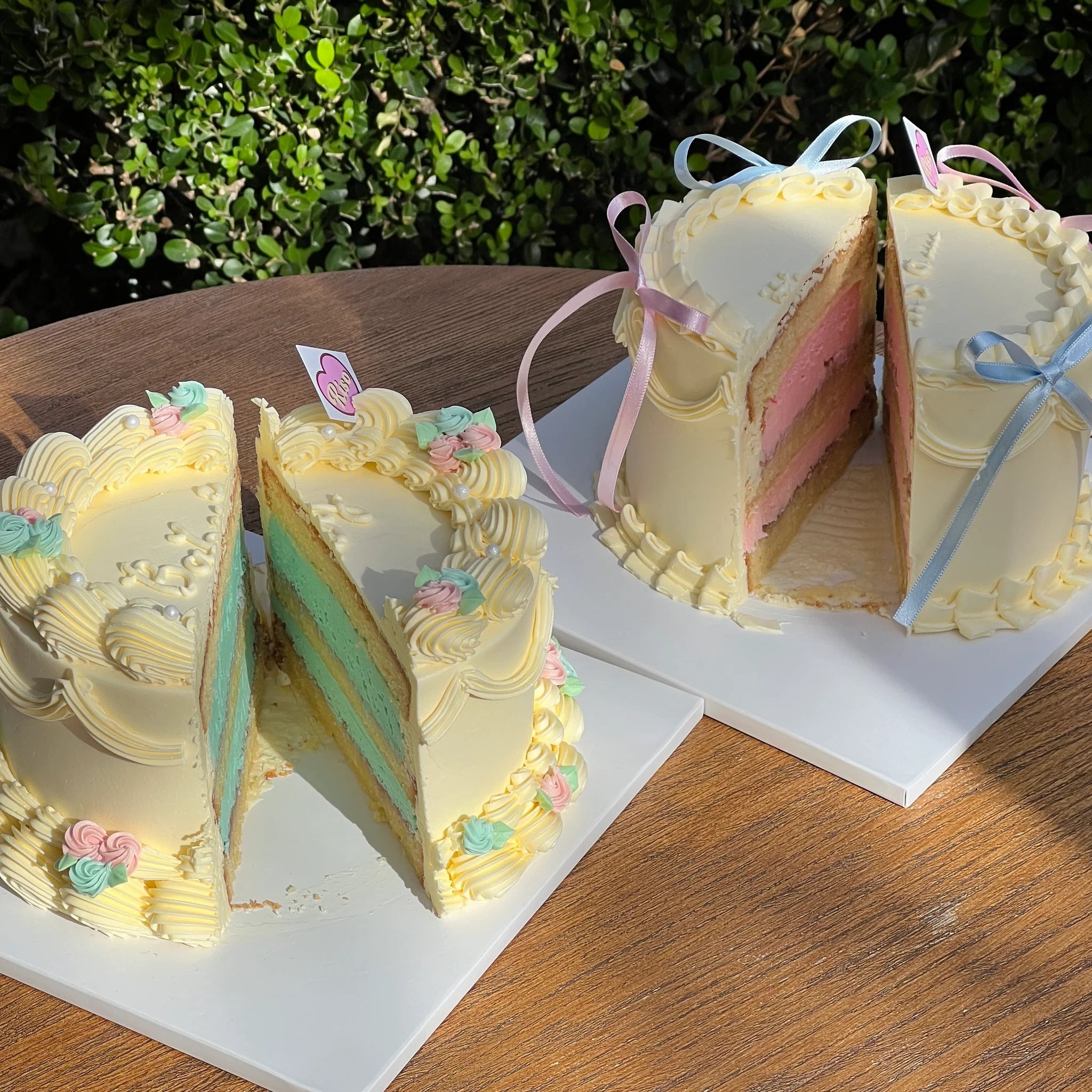 Gender reveal cakes sliced open to show vibrant pink and blue sponge layers inside, perfect for baby showers and gender announcement parties