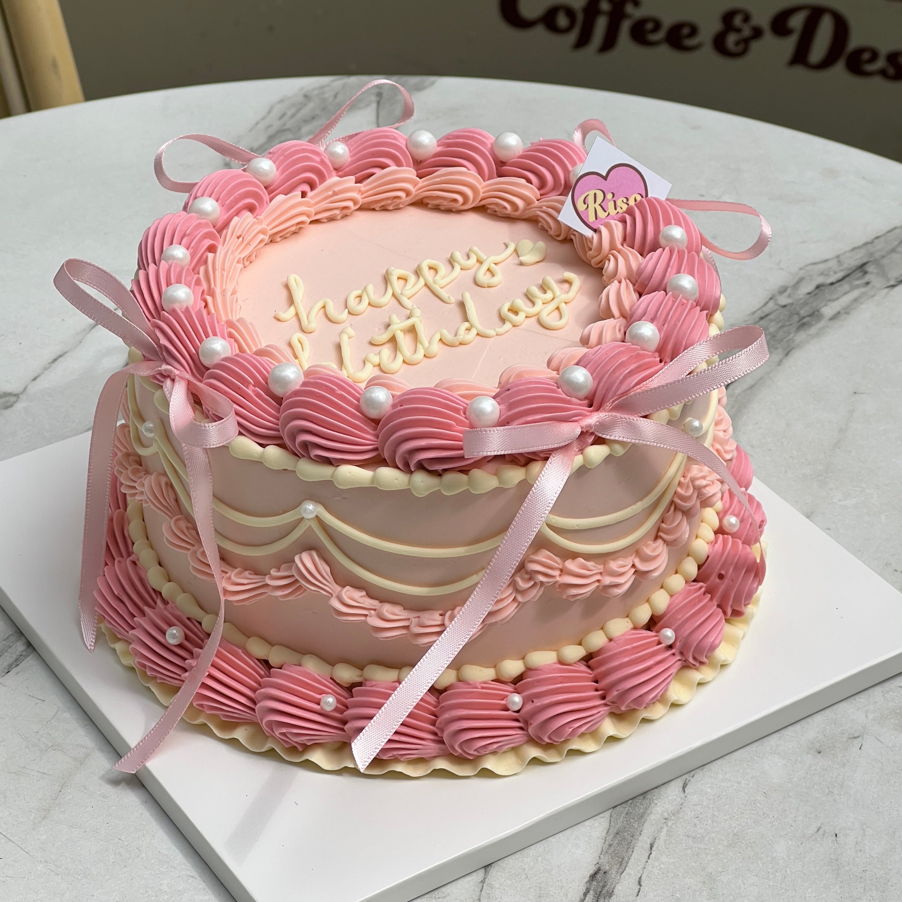 Dreamy pink cake with vintage swirls, soft ribbon bows, and balletcore charm 🩰💖