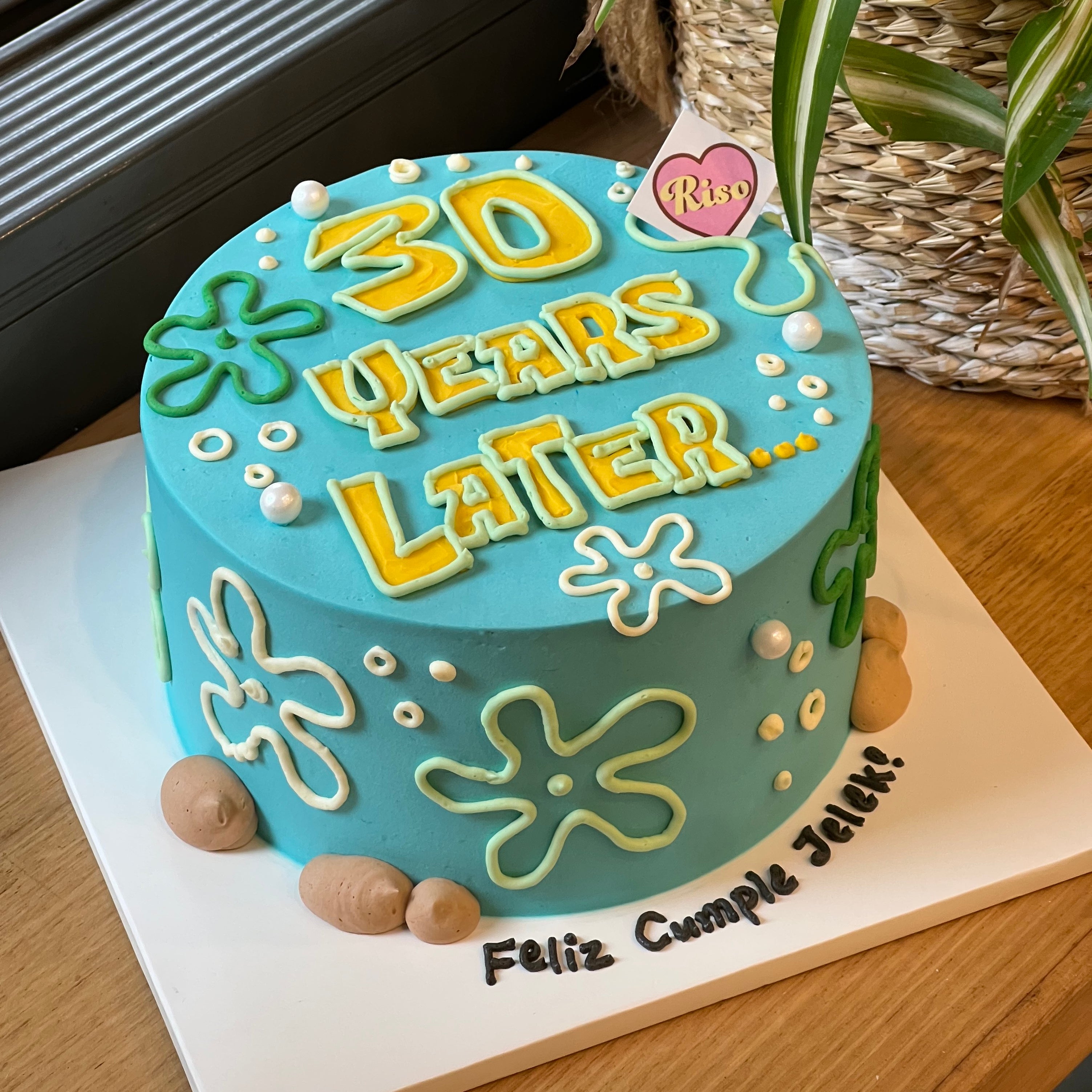Blue cartoon-style cake with “30 Years Later…” text and SpongeBob-themed decorations