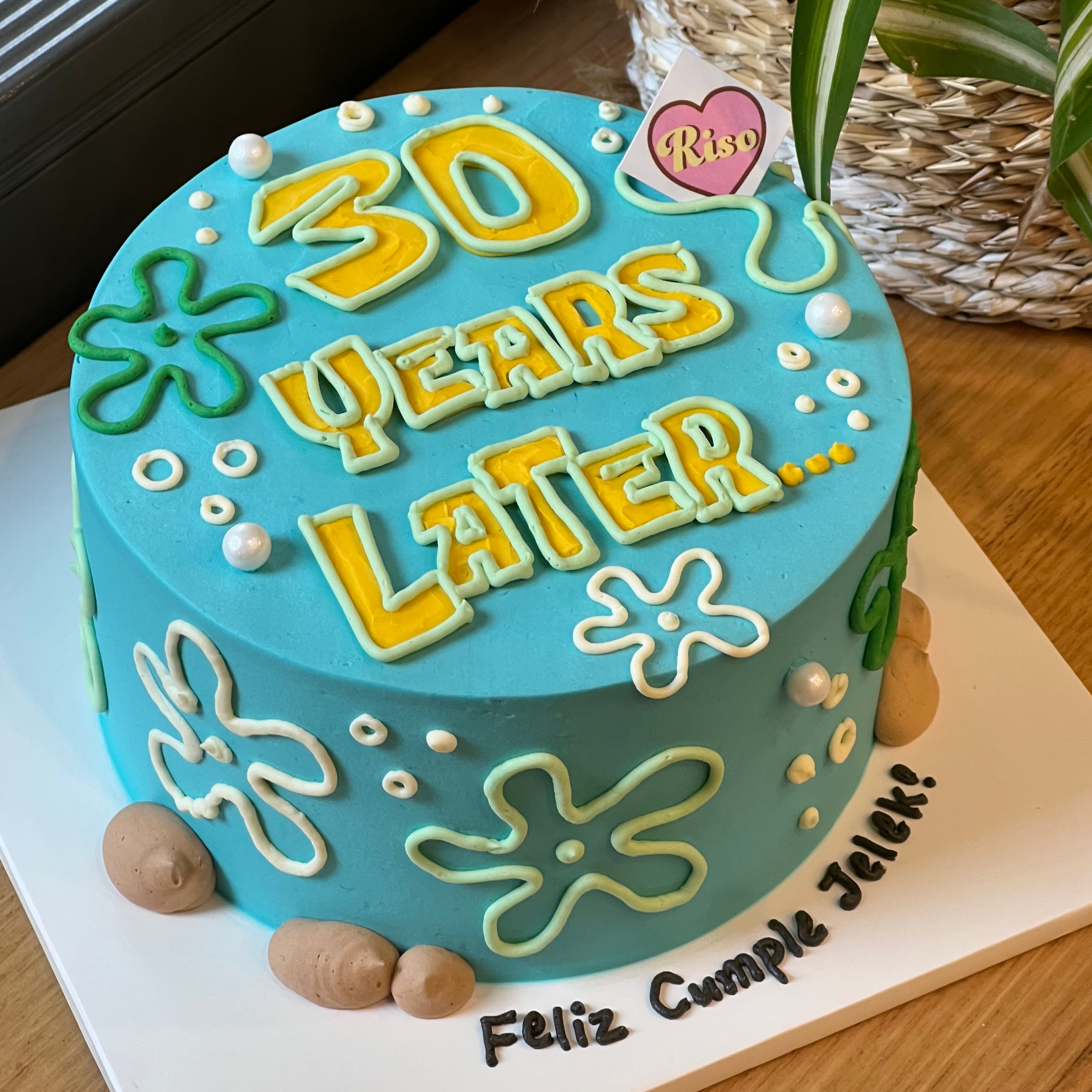 SpongeBob-inspired birthday cake with ocean elements, colorful piping, and “30 Years Later” lettering