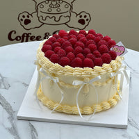 Balletcore-inspired raspberry cake with vintage-style piped cream, white ribbon bows, and a crown of juicy fresh raspberries — perfect for elegant celebrations