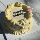 Top view of vintage cream birthday cake with piped border and pearl accents