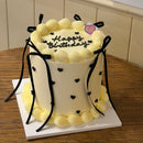 Elegant balletcore-inspired birthday cake with piped black hearts and silky ribbon details