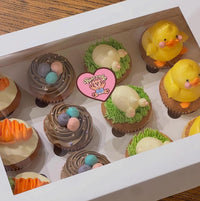 Adorable spring cupcakes in a gift box, topped with playful Easter characters and vibrant buttercream details, radiating cozy picnic vibes